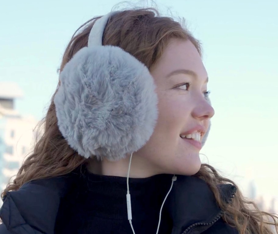 woman wearing oversized gray ear muffs