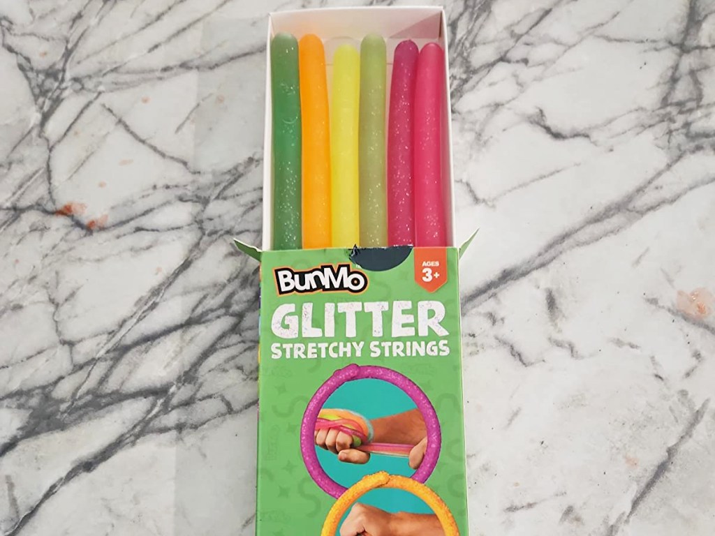 opened box of glittery stretchy strings