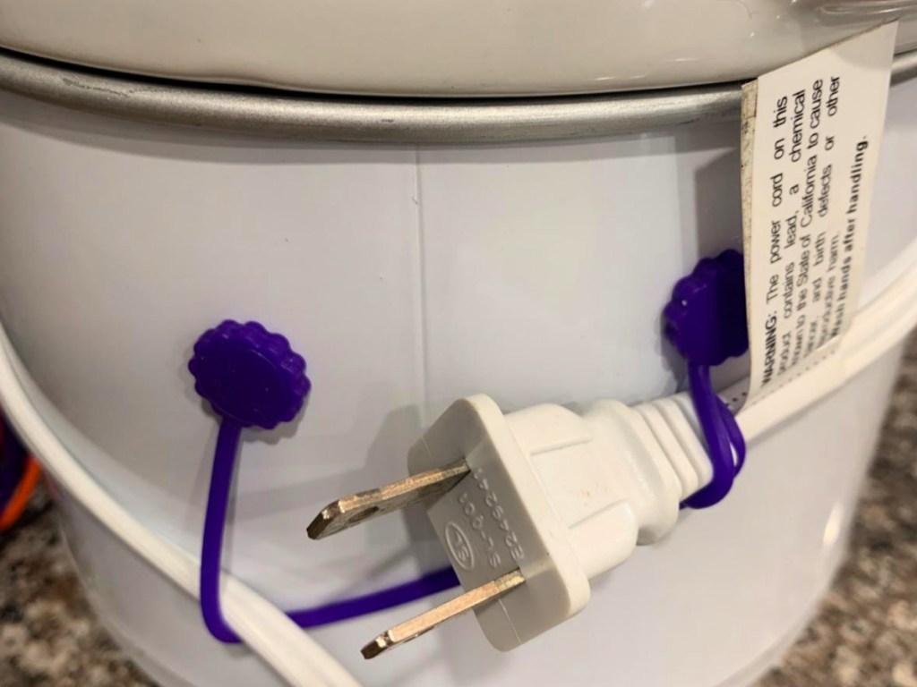 Purple silicone, cable, tie, holding up cord of crockpot