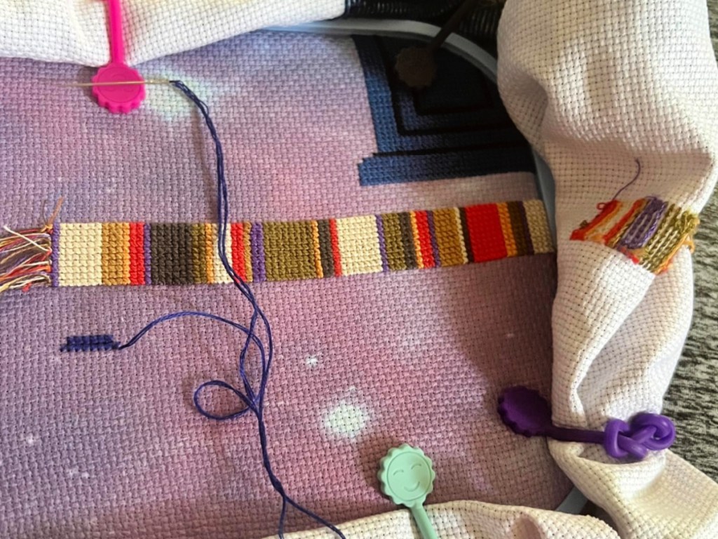 Colorful cable ties holding up fabric in crochet project