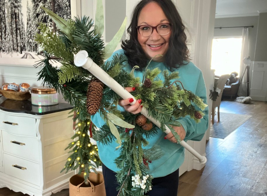 Woman pointing to her Christmas Garland Hack DIY project