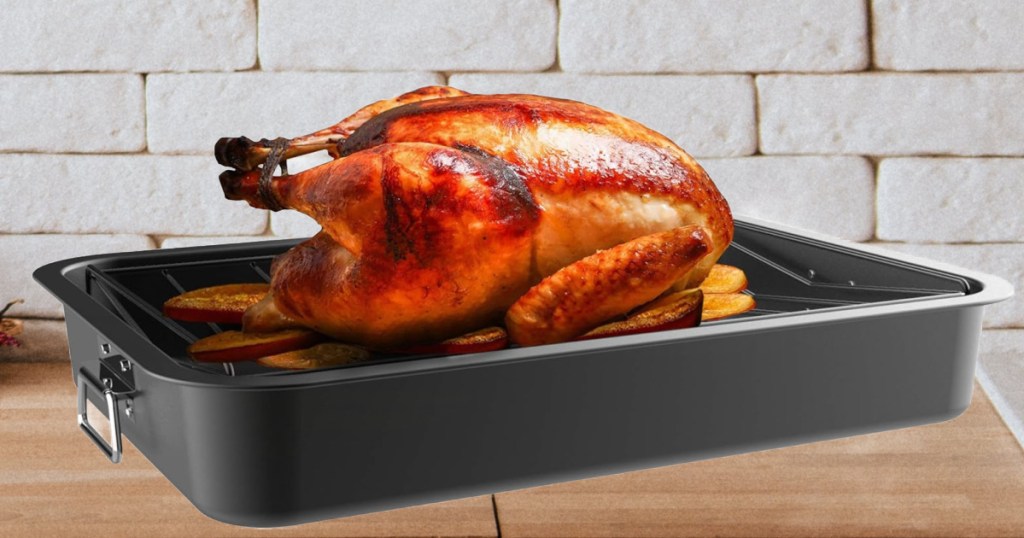 A cooked turkey in a classic cuisine roasting pan