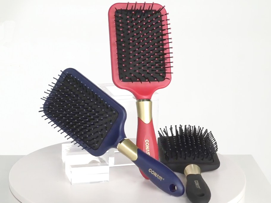 red, blue, and black conair hair brushes