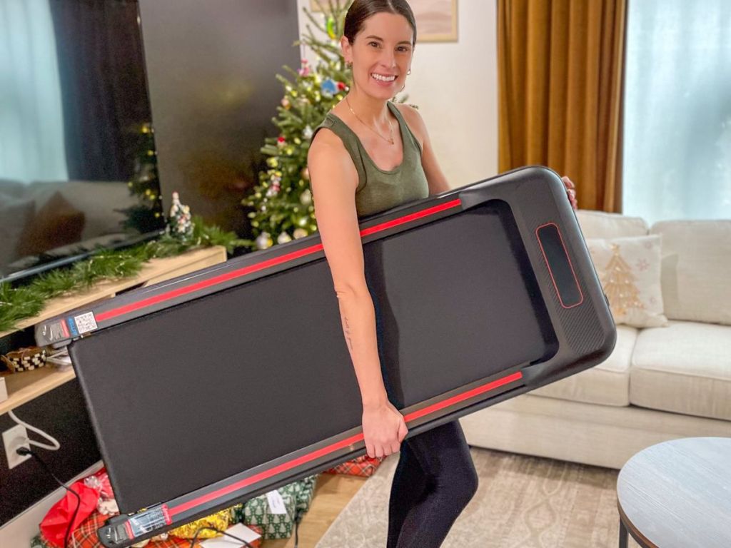 Woman holding a compoact under desk treadmill 