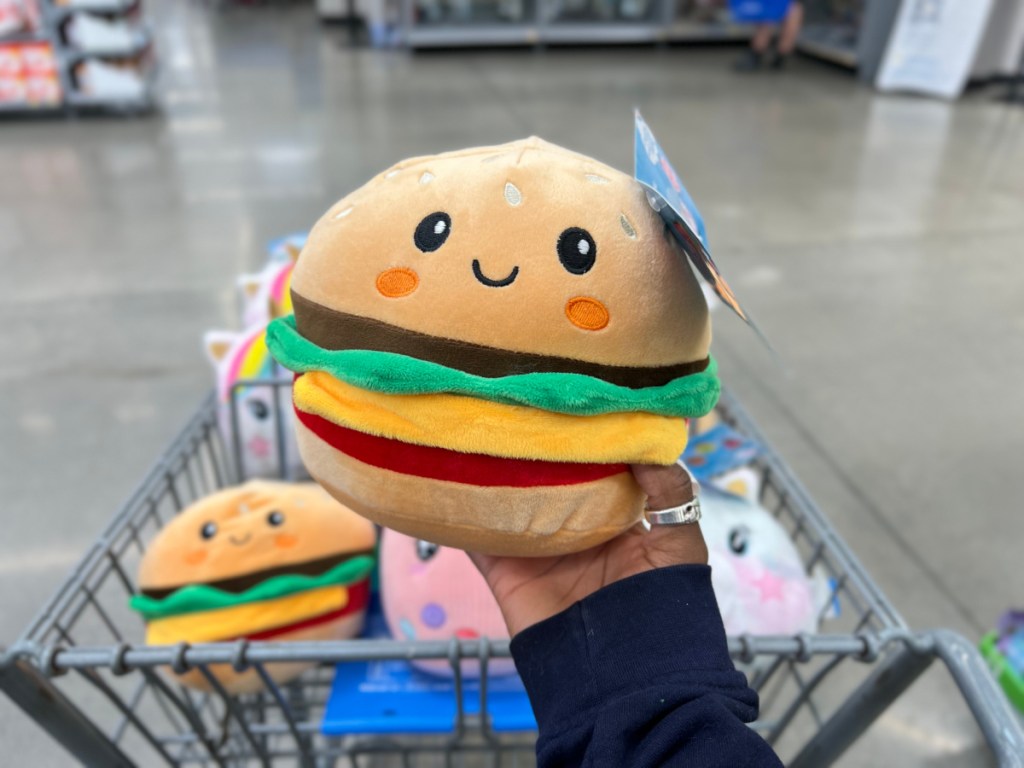 person holding up Cuddly Crew Cheeseburger Squishie in walmart