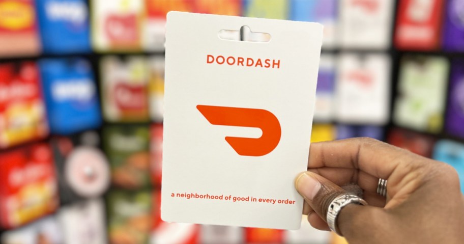 hand holding up a doordash gift card