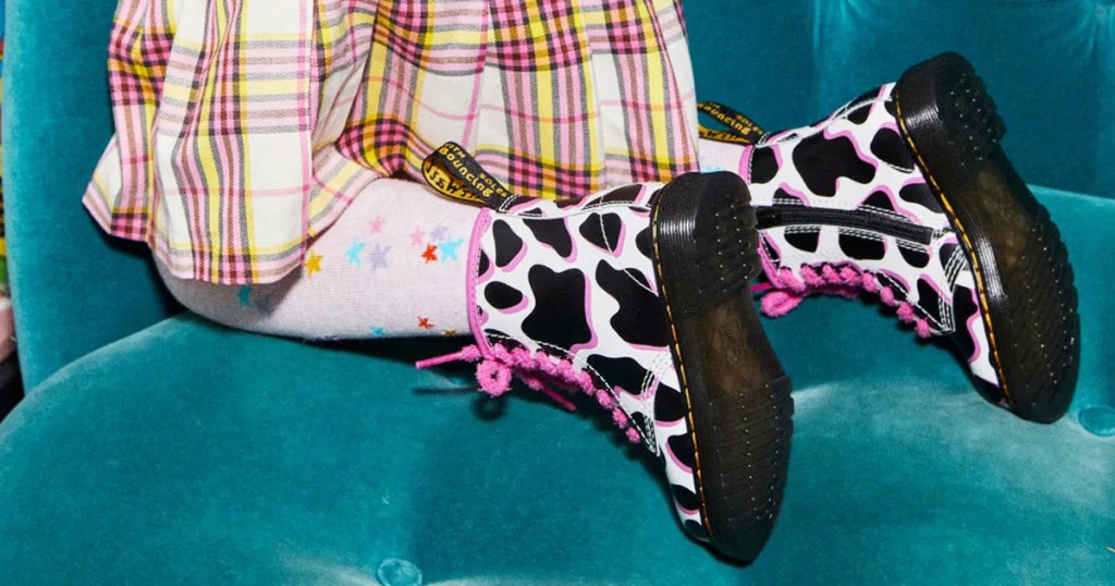 girl wearing a pair of cow print boots