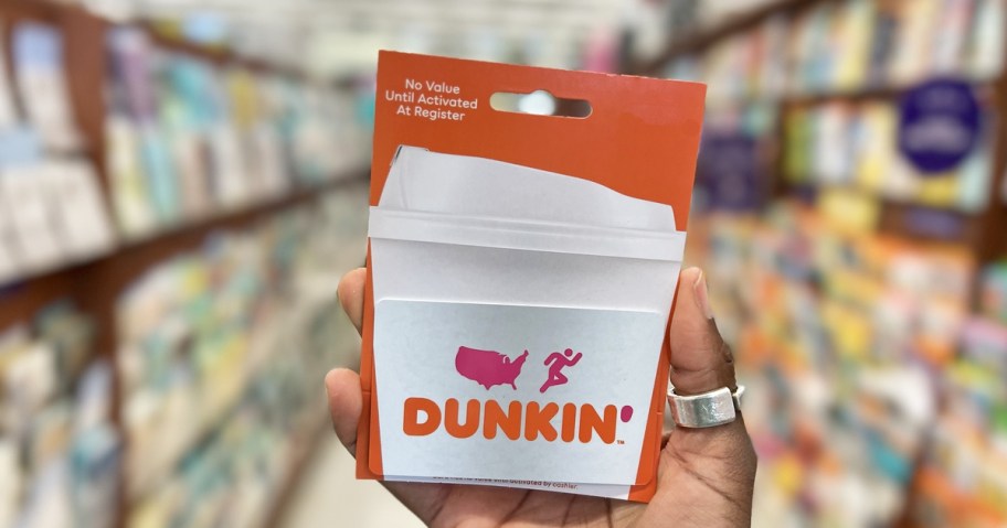hand holding up an orange and white Dunkin' gift card