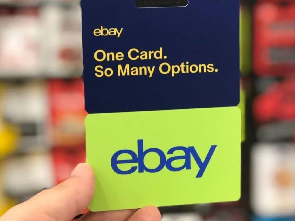 A hand holding an EBay Gift Card