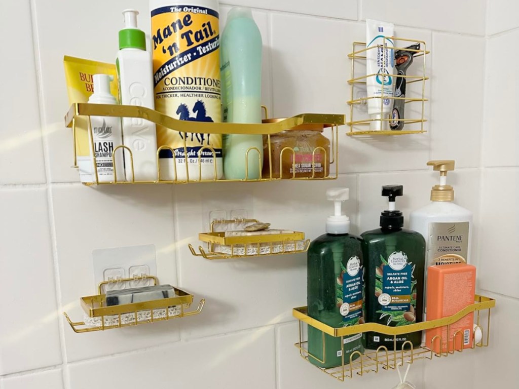 personal hygeine products in a gold adhesive shower caddies