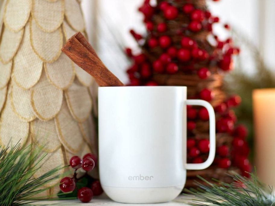 A white Ember Mug with a Cinnamon Stick in it