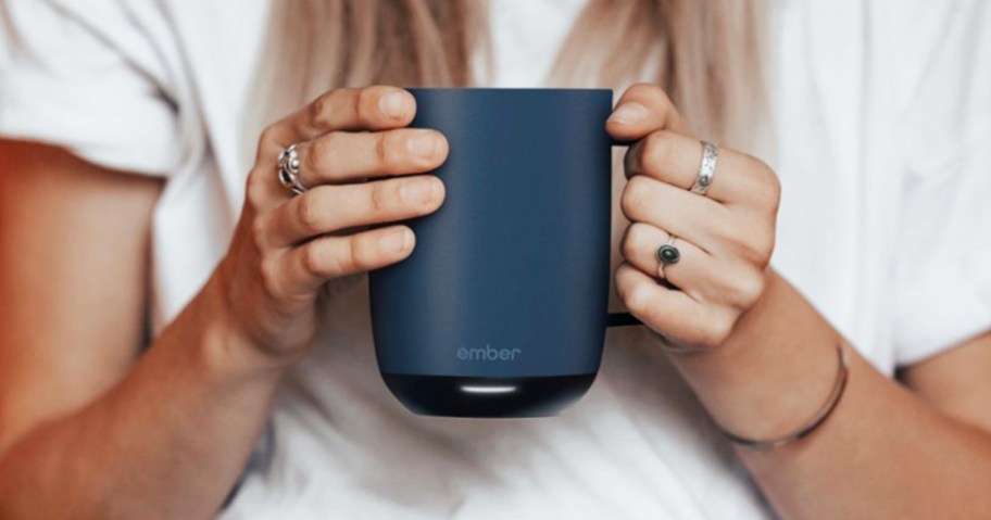 woman holding a blue coffee mug