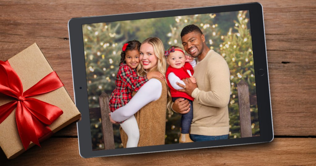 Holiday picture of family displayed on iPad next to wrapped present