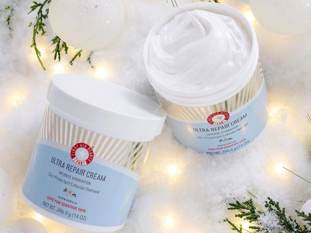 2 tubs of First Aid Beauty Repair Cream in the snow