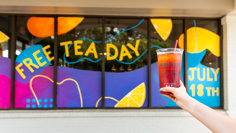 McAlisters Free Tea Day sign with a hand holding up a free drink
