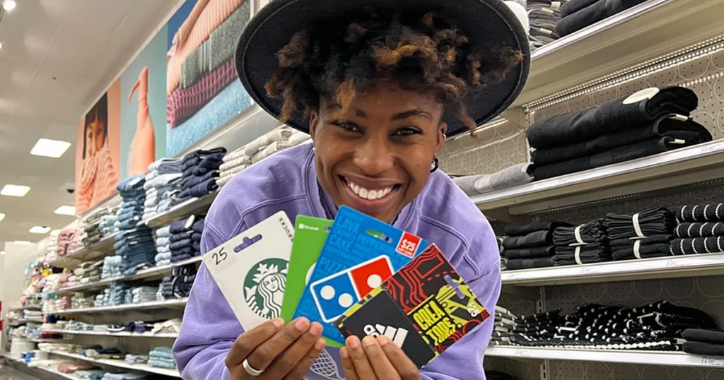 woman holding up a variety of gift cards