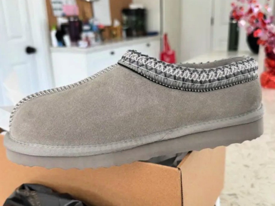 Gray slip on slippers on box