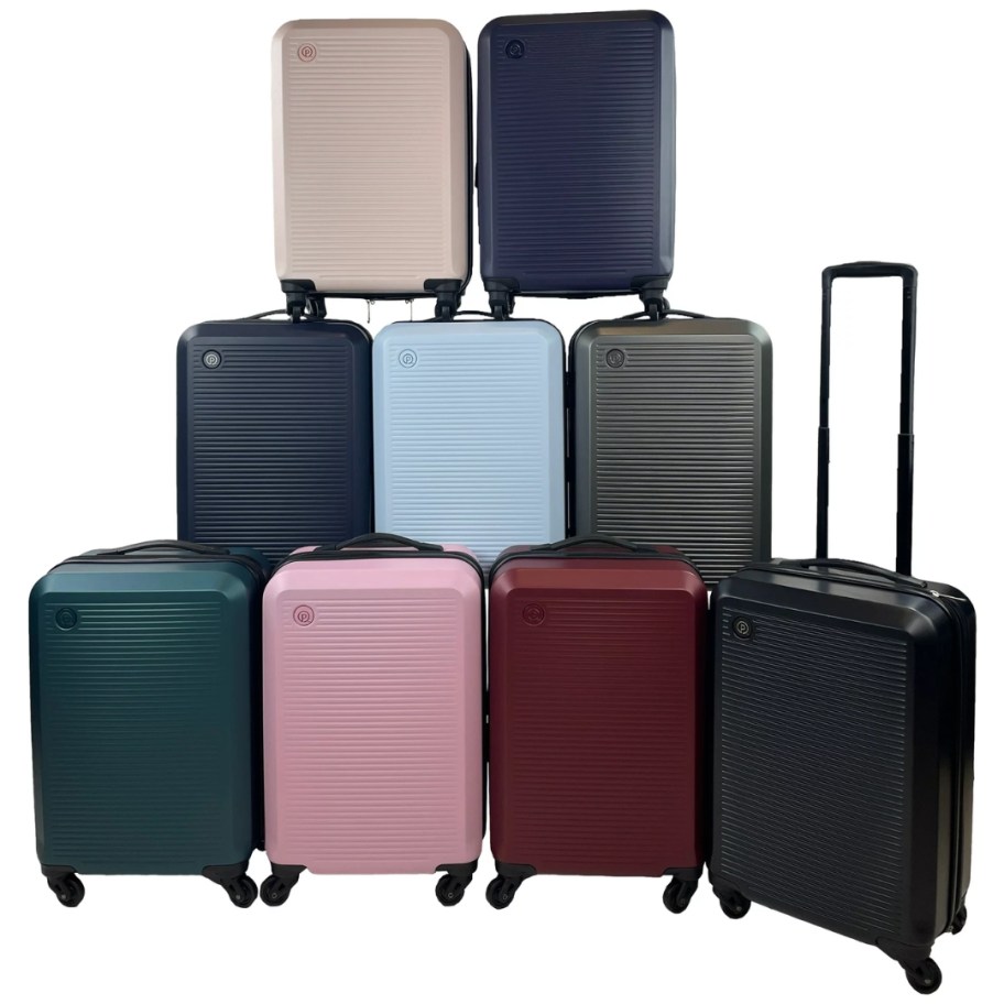 9 different colors of hardsided carry on luggage stacked
