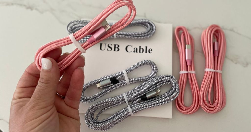 Firsting iPhone Charging Cables silver and pink, pink in a womens' hand