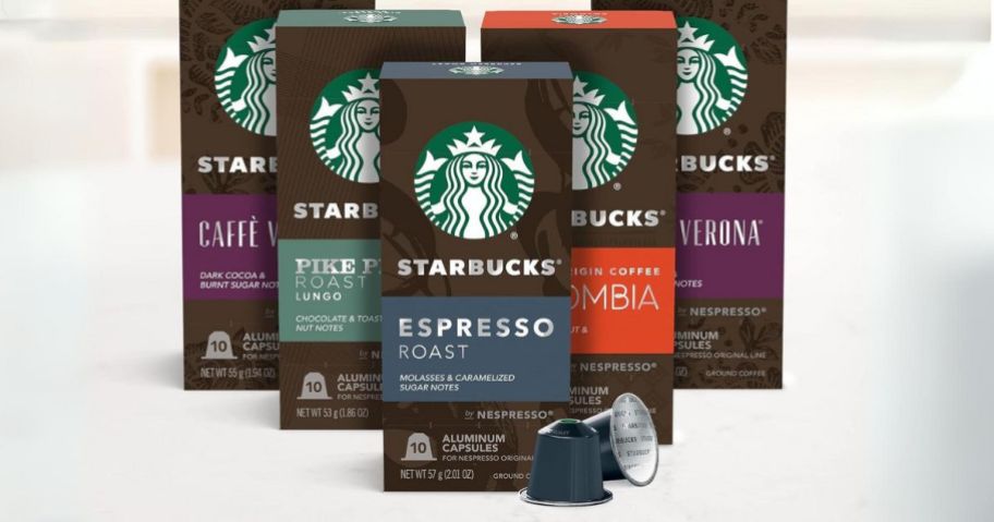 five boxes of Starbucks Nespresso pods in different flavors with 2 pods laying in front