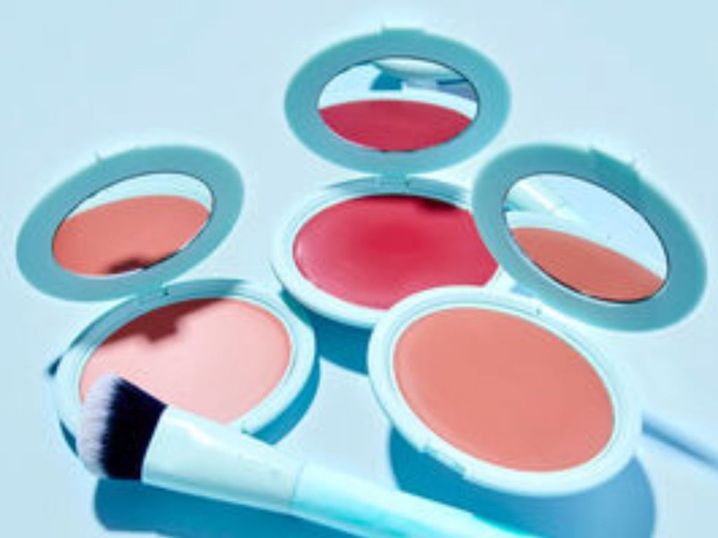 3 different colors of blush compacts open with a blush brush on one