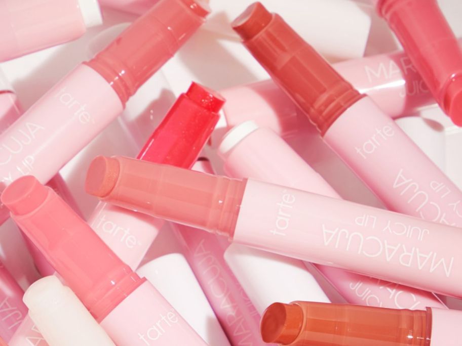 various different colors of Tarte Maracuja Juicy Lip balms laying on each other