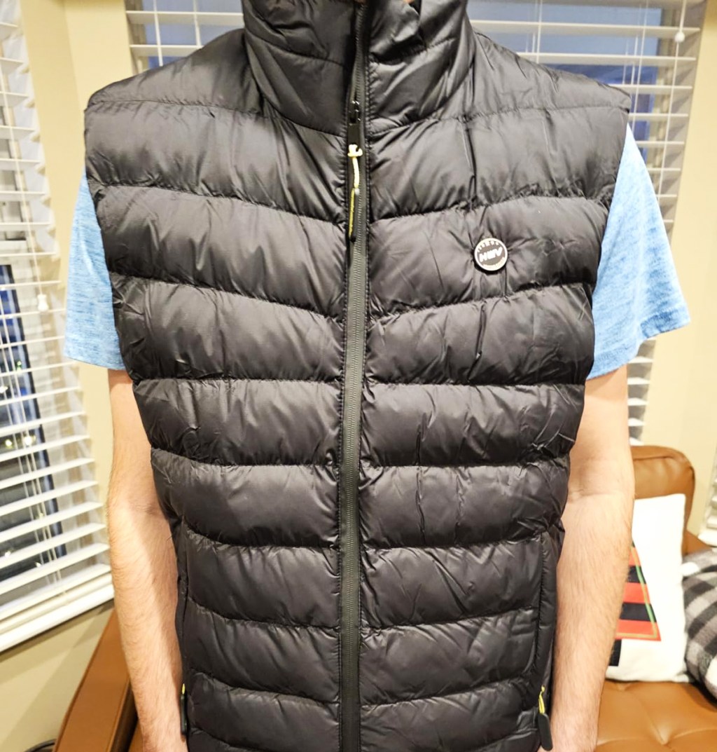 man wearing a black puffer vest with blue t-shirt