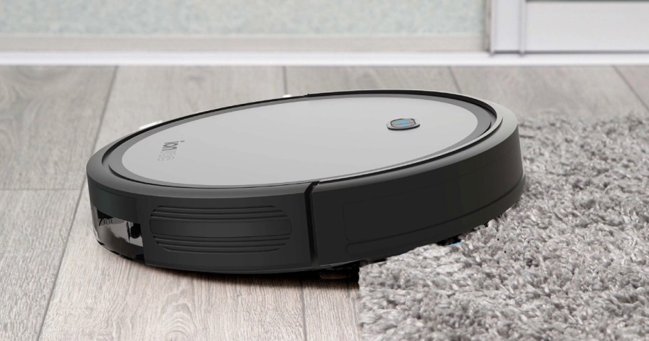 robot vacuum moving from hardwood to plush area rug