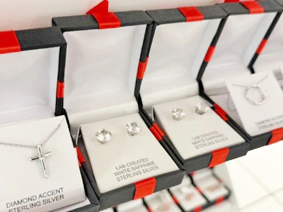 stud earrings in black jewelry boxes with red bows