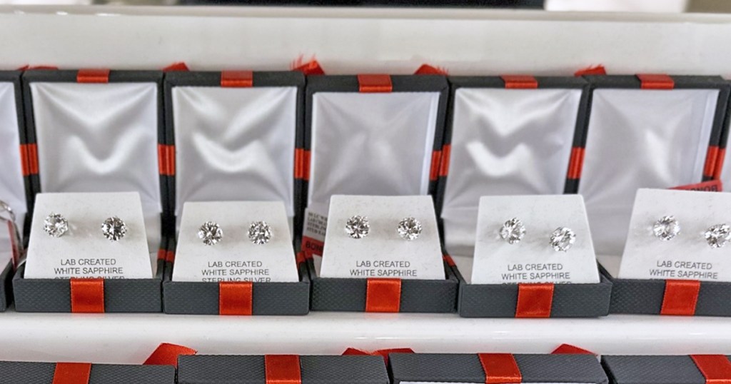 stud earrings in black jewelry boxes with red bows