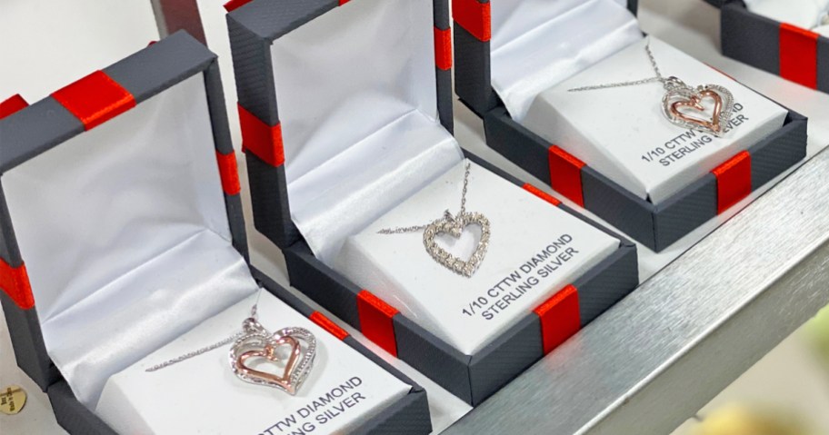 heart necklaces in black jewelry boxes with red bows