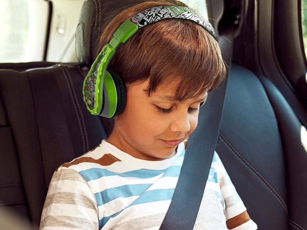 boy in car wearing Teenage Mutant Ninja Turtle Headphones