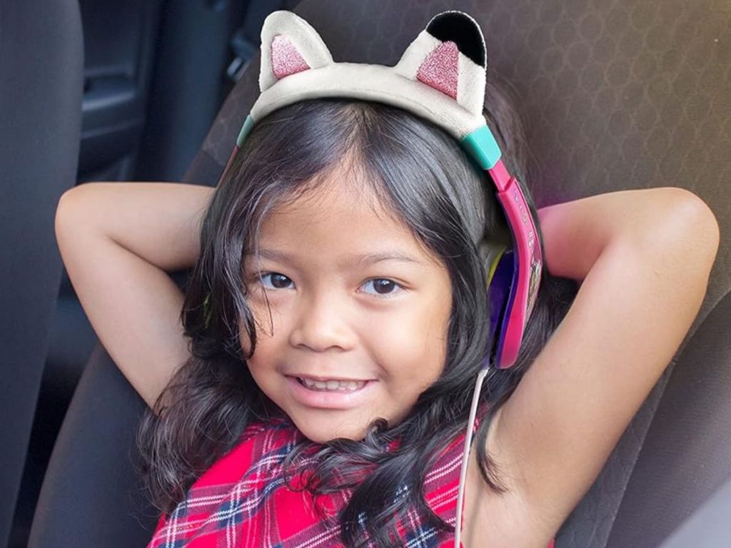 Little girl wearing Gabby's Dollhouse headphones