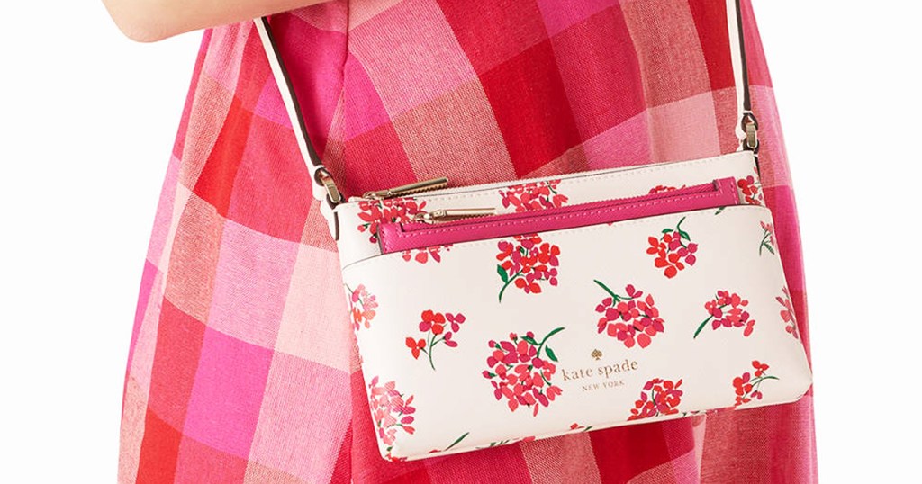 woman in pink plaid dress with white and prink floral print crossbody