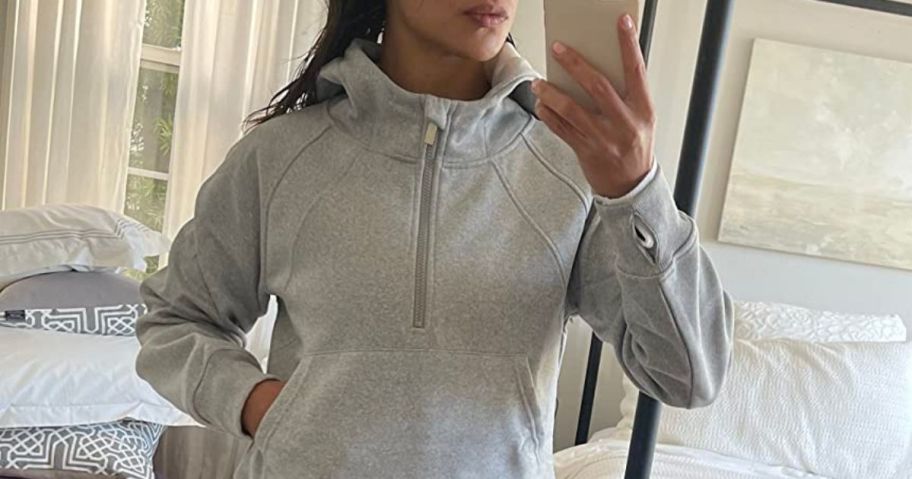 Woman wearing a laslulu cropped hoodie in the mirror