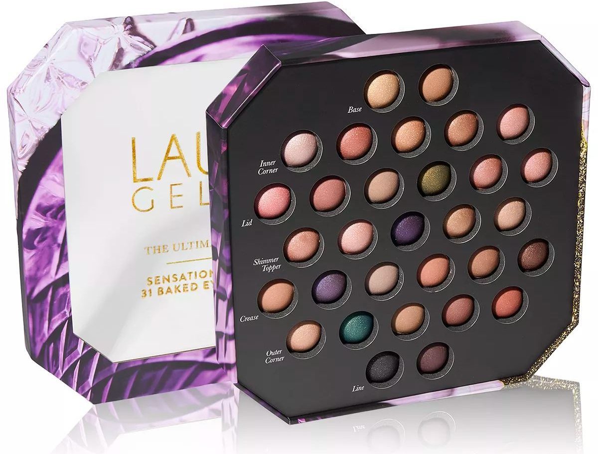 Laura Geller Beauty Ultimate Palette - Sensational Soirée - 31 Baked Eyeshadows with lid off and propped behind the palette stock image