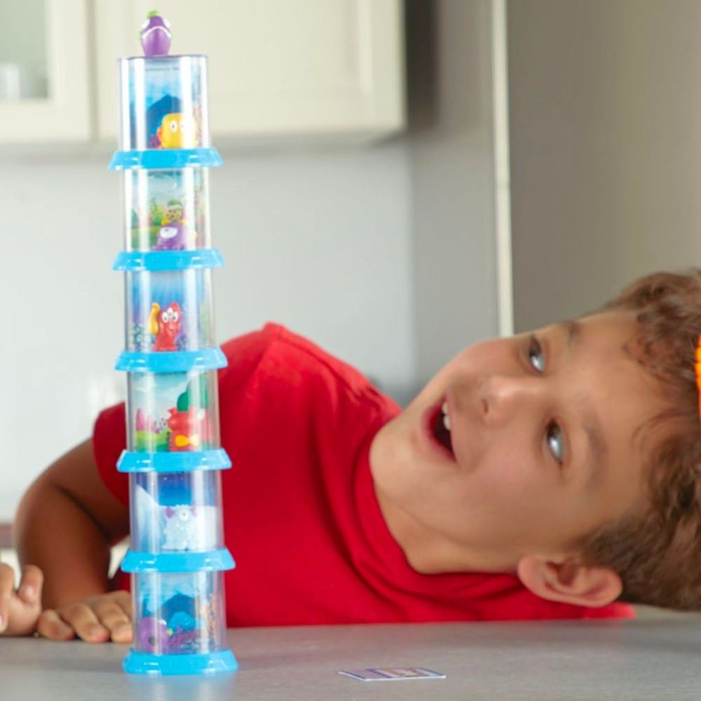 a little boy playing with a stack of Learning Resources Beaker Creatures Series 1