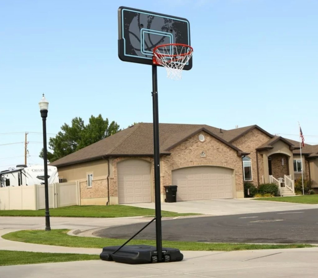 basketball hoop on driveway in neighborhood