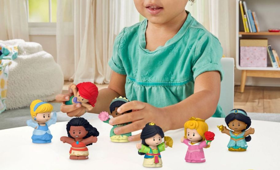 little girl playing with fisher price little ppl