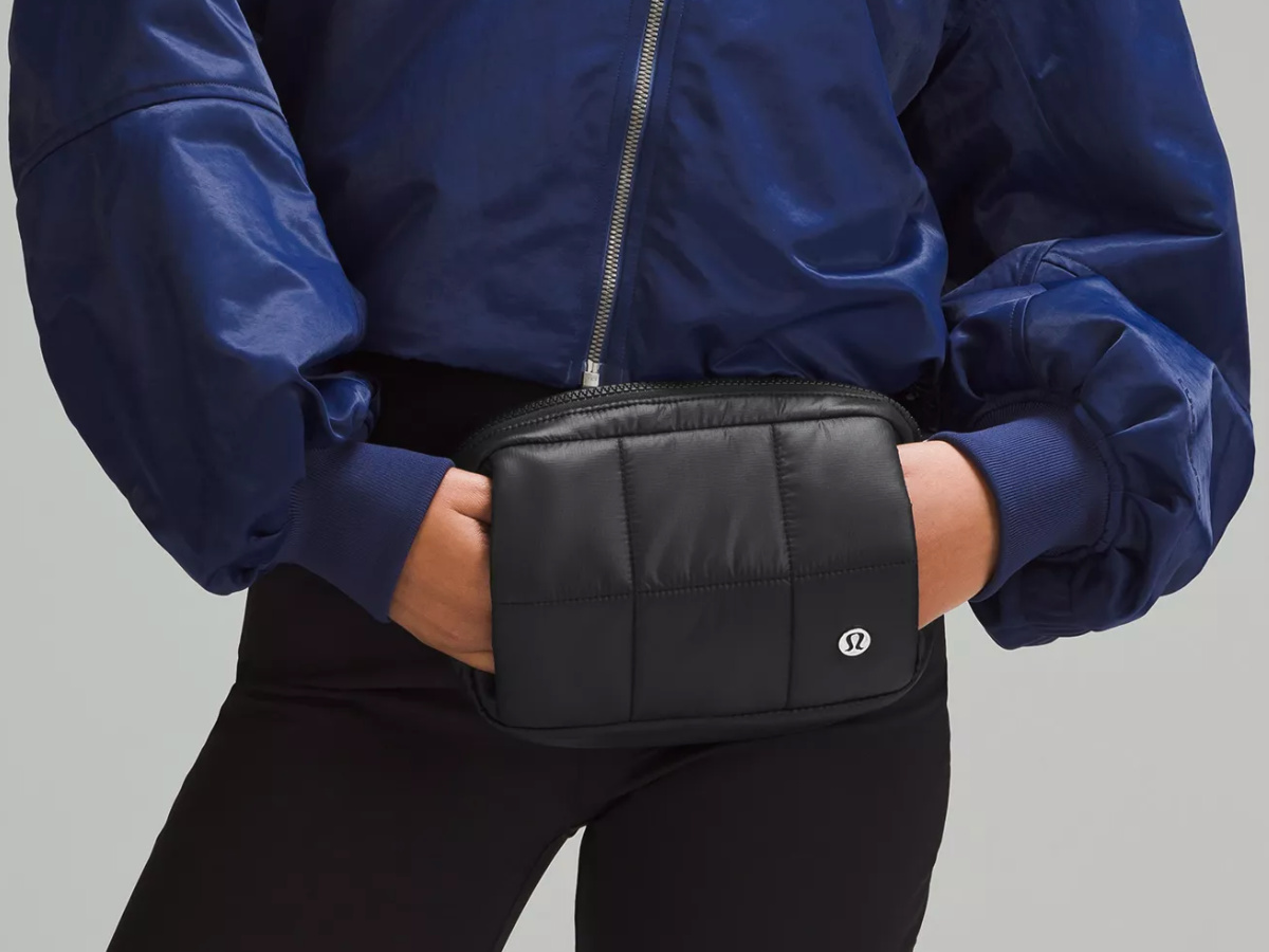 woman wearing black Lululemon belt bag with hand warmer