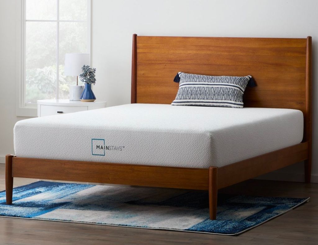 Mainstays 10 inch Memory Foam queen Mattress on a natural wood bed frame with a throw pillow