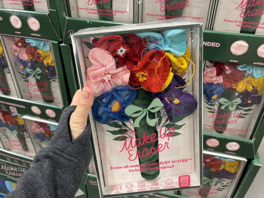 A hand holding a box of Makeup Erasers in the shape in a bouquet 