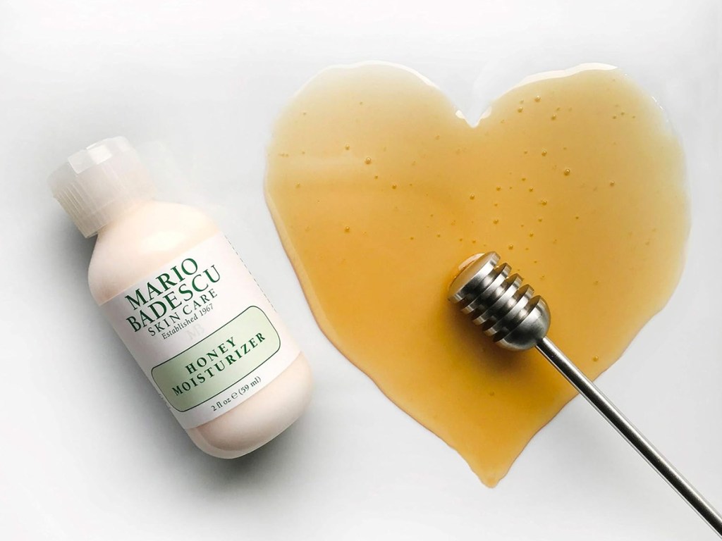 small bottle of Mario Badescu Honey Face Moisturizer next to honey in the shape of a heart