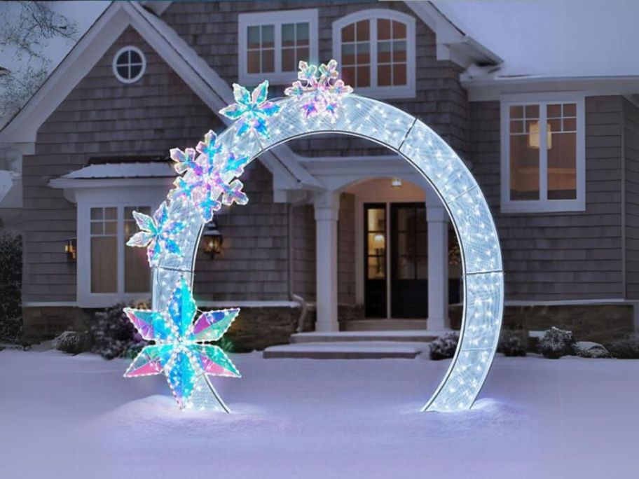 Member's Mark 8' Pre-Lit Arch w/ Prismatic Snowflakes in front yard