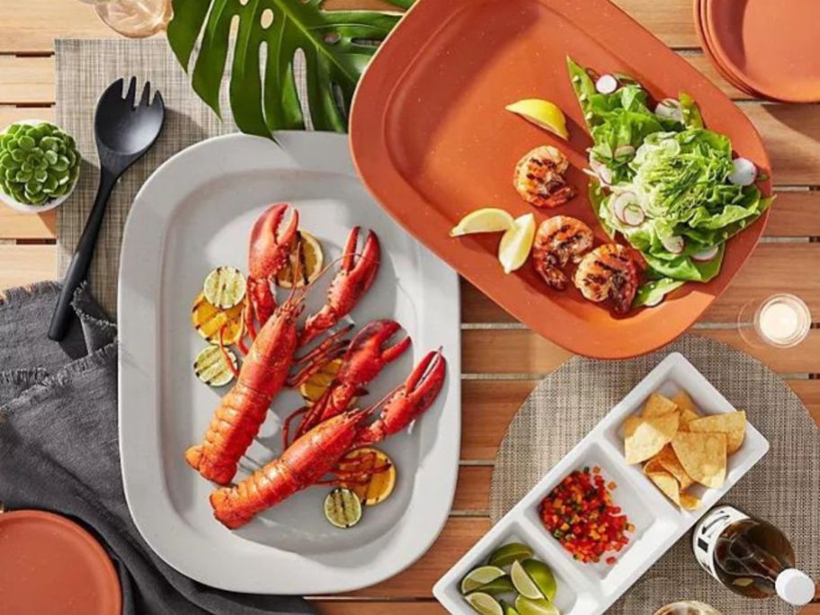 Member's Mark Bamboo Melamine Serveware set filled with food including lobster, shrimp and salad