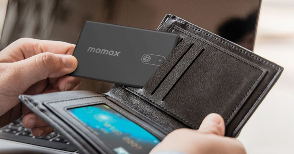 man putting a momax tracker card into his wallet