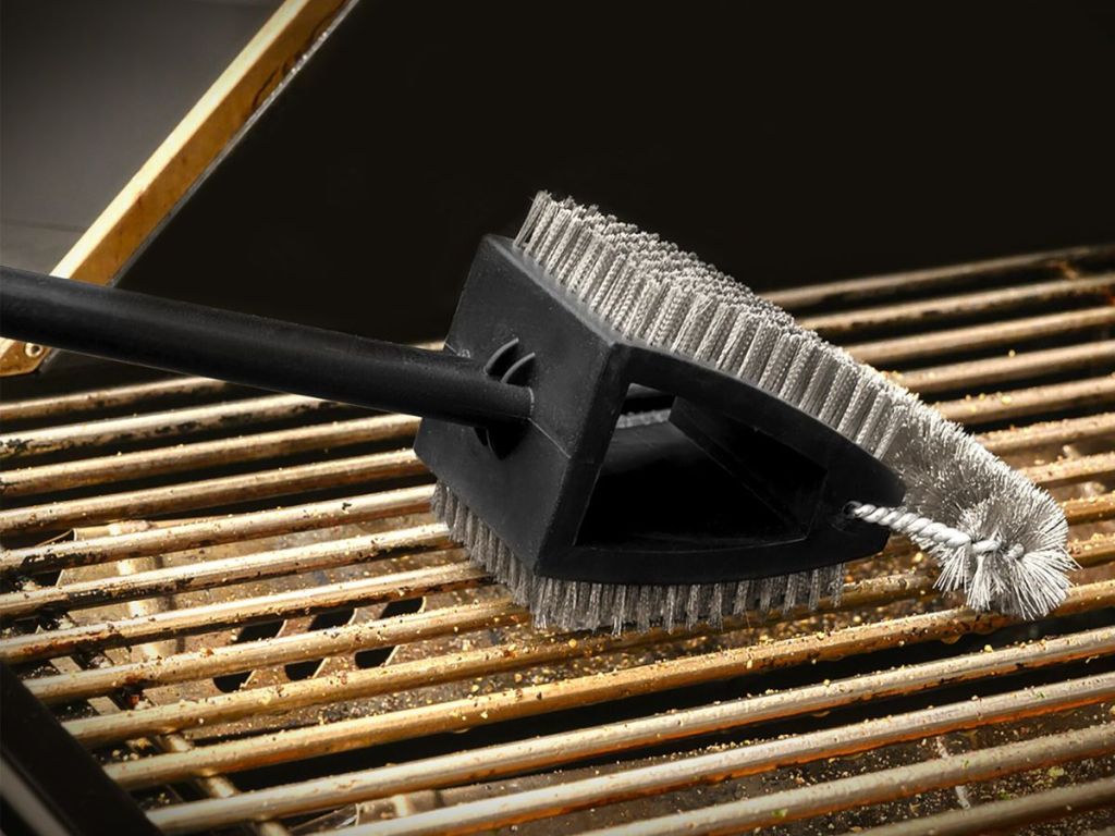 Grill being cleaned with a Mr BBQ grill brush