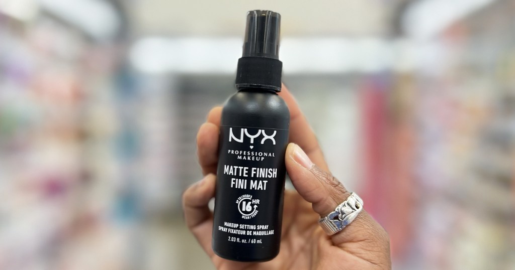 hand holding a black bottle of NYX Matte Finish Setting Spray