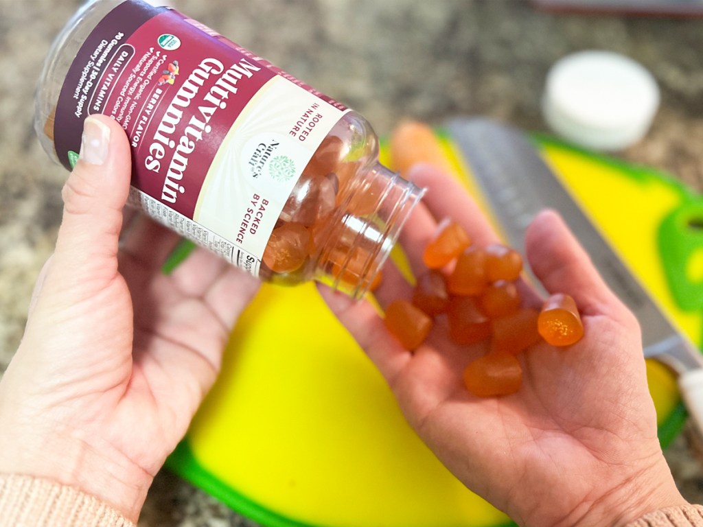 hands pouring out bottle of Nature's Craft Organic Multivitamin Gummies
