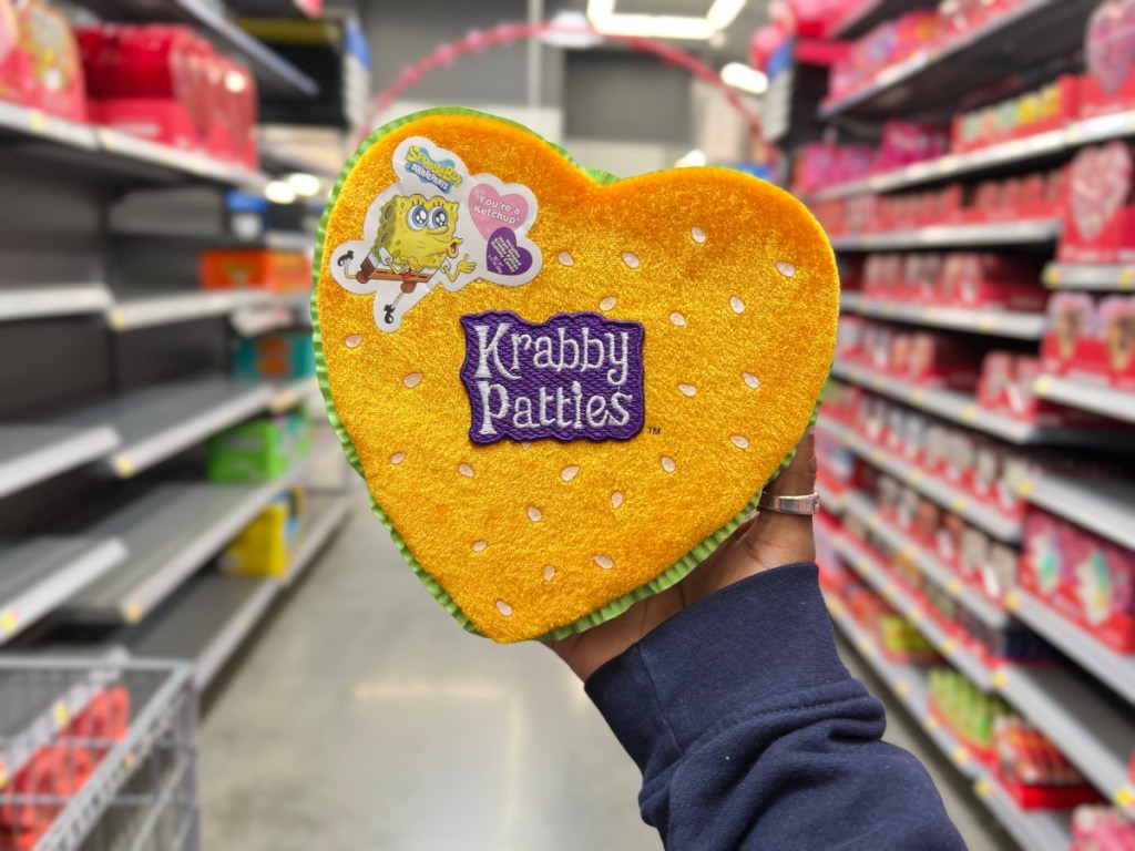 person holding Nickelodeon SpongeBob Krabby Patty Gummy Heart Box in walmart